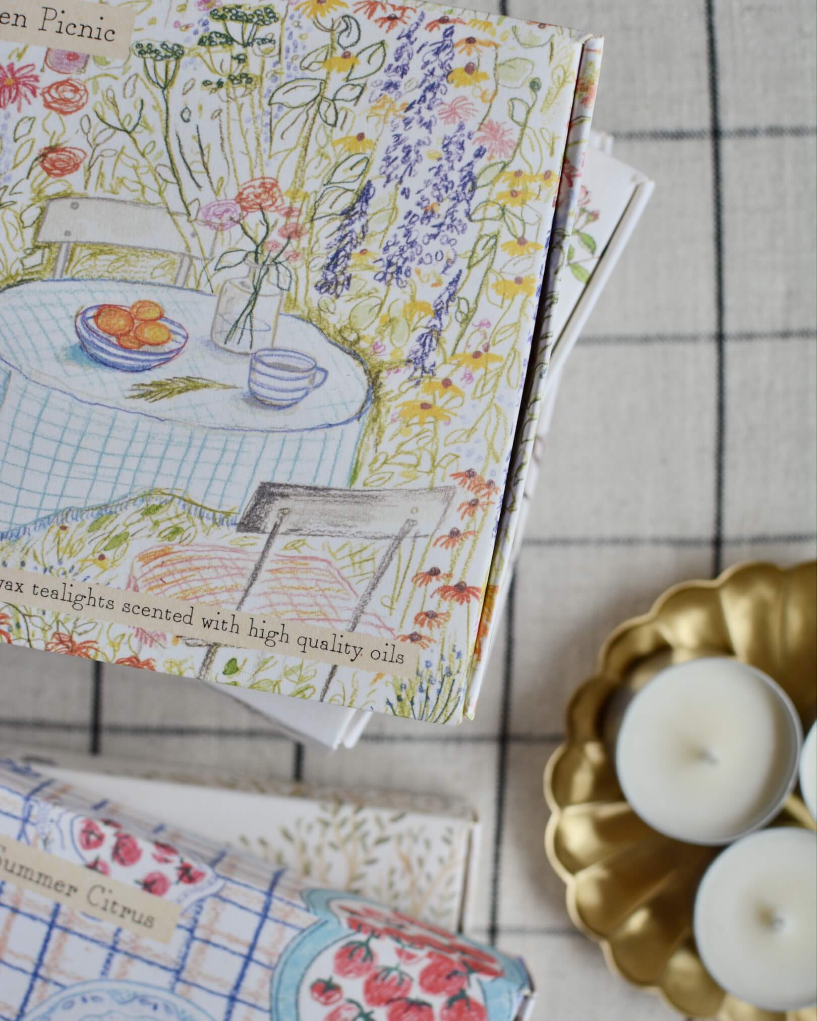Garden Picnic scented tea lights with a hand-illustrated box design, depicting a summer garden.