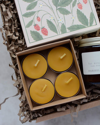 A candle gift box containing a scented rose candles, 4 beeswax tea lights and a box of strawberry-design matches.