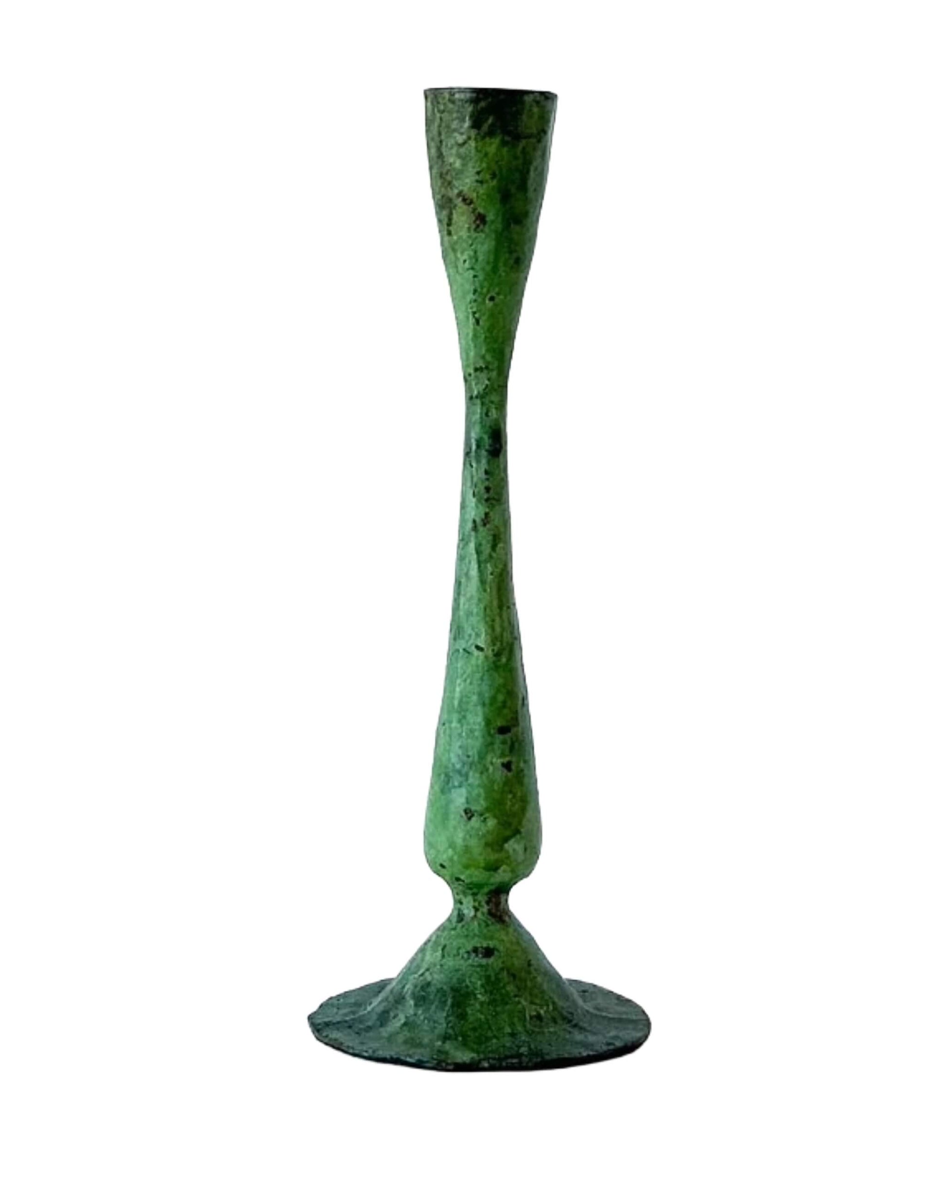 A green verdigris tall candle holder, for dinner candles.