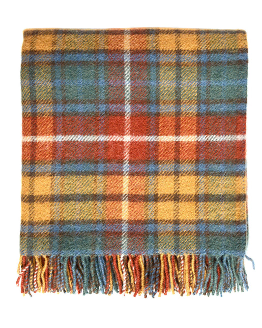 A plaid wool blanket, with tones of red, yellow and blue, on a white background. 