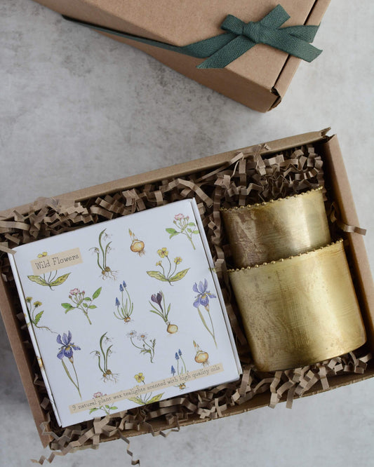 Gift set with a box of floral tealights in an illustrated box and a pair of brass tealight votives.