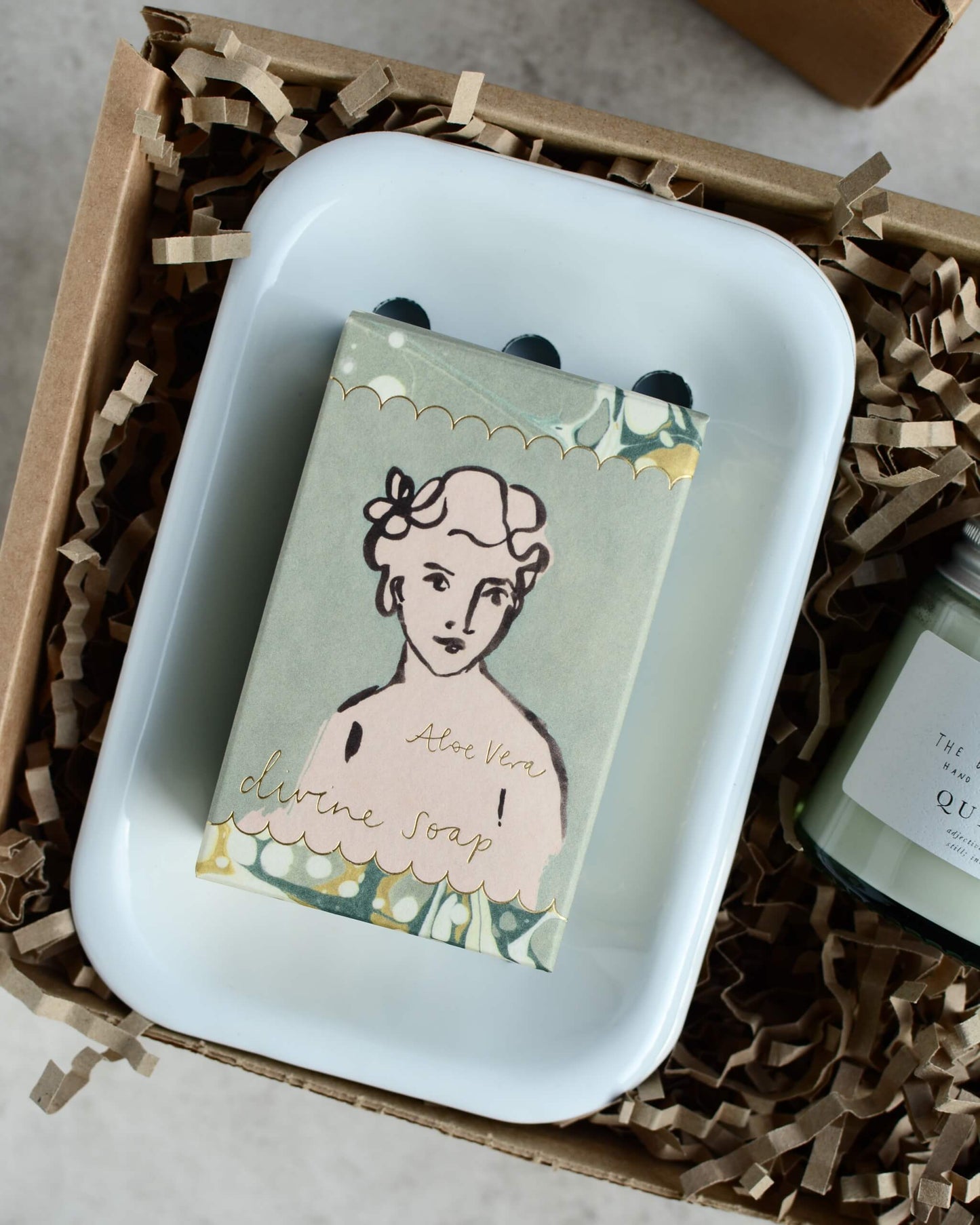 A green soap and white soap dish, in a gift box.