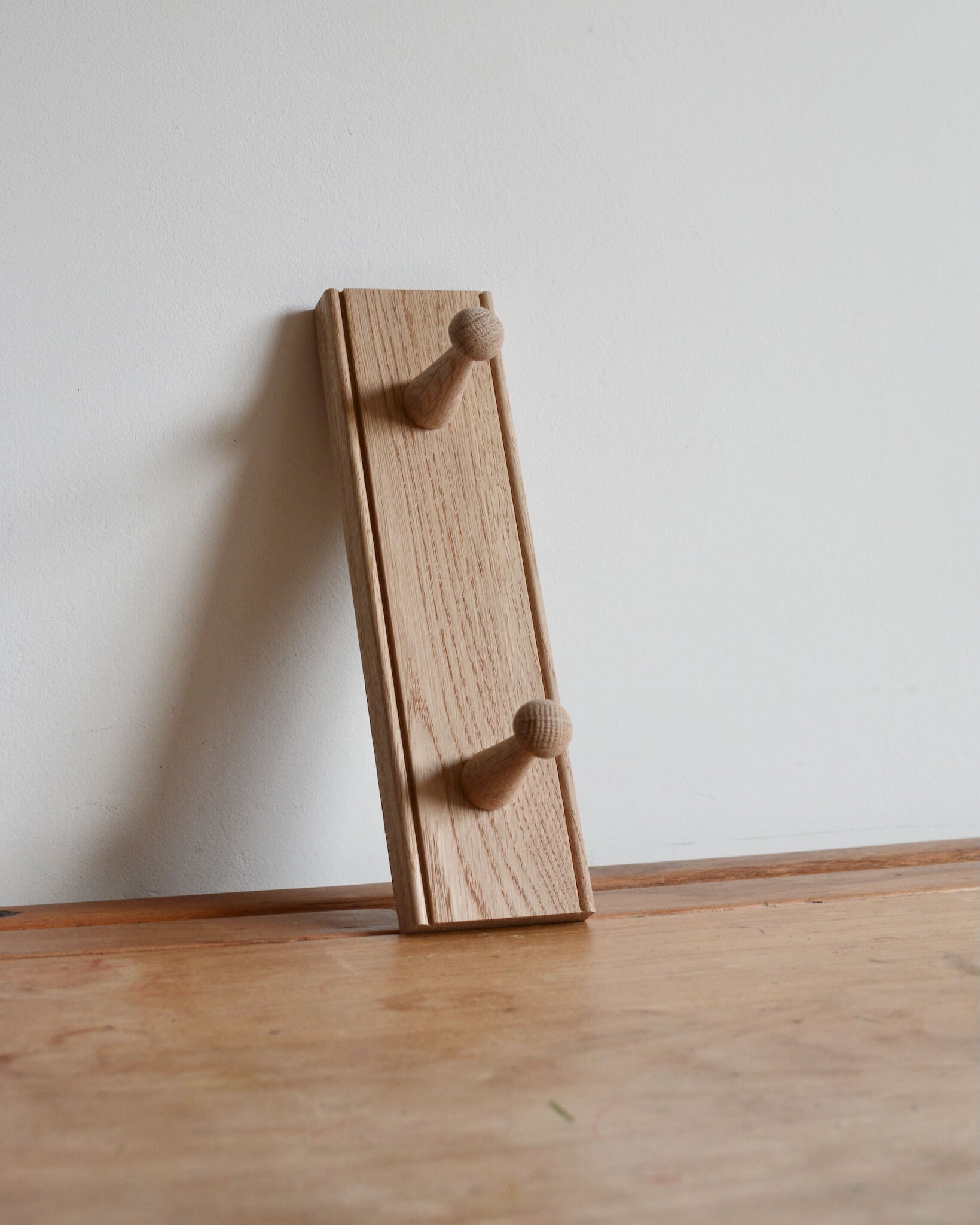 An oak peg rail with 2 pegs by Creamore Mill
