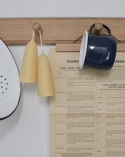 An oak peg rail, styled with candles and kitchen accessories