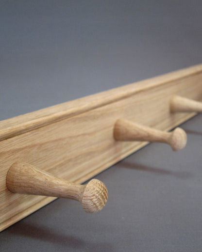 Detail of oak grain on a wooden peg rail by Creamore Mill