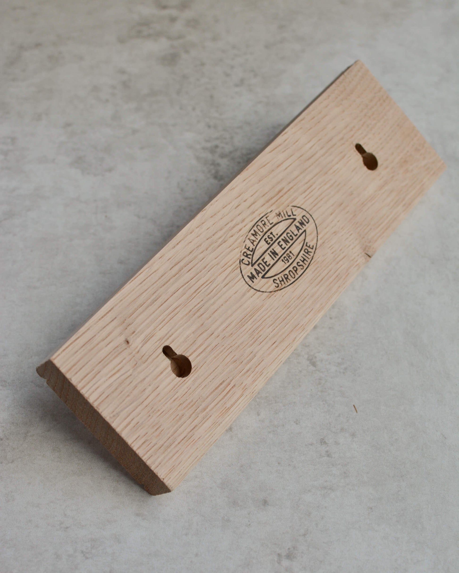 Back of oak shaker peg rail showing keyhole fixings