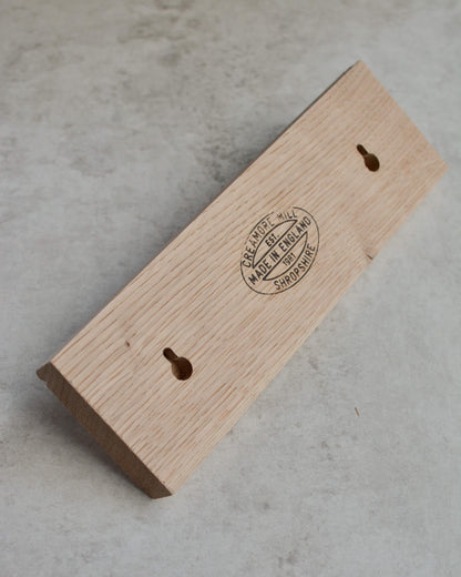 Back of oak shaker peg rail showing keyhole fixings