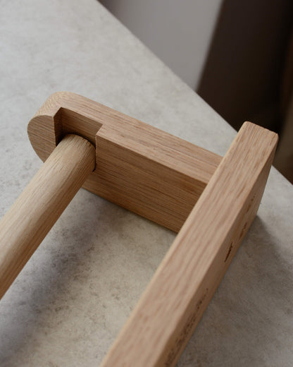 Close-up shit of a solid oak toilet roll holder, shown from above