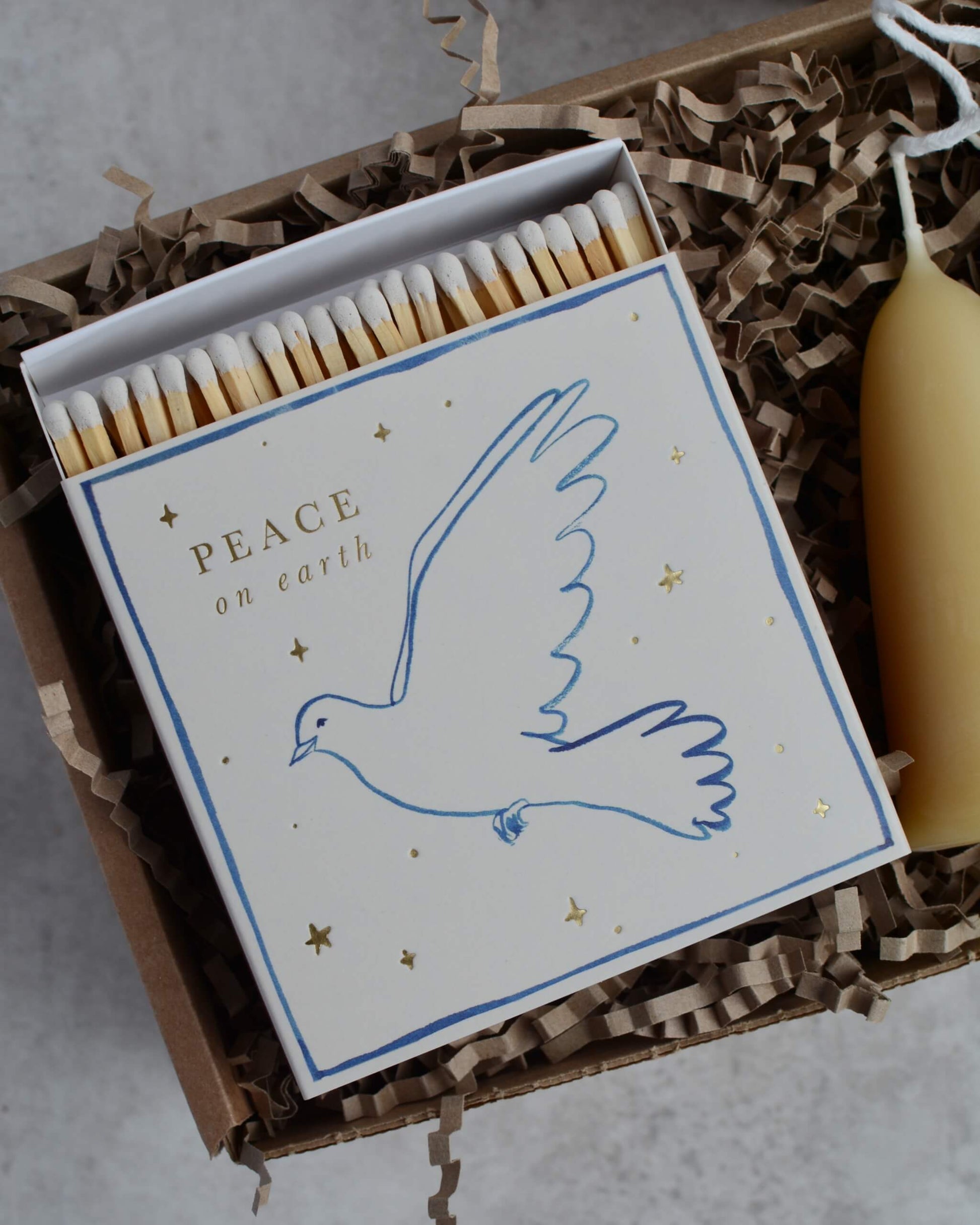 Matches with a dove design and 'Peace on Earth' text in a decorative box.