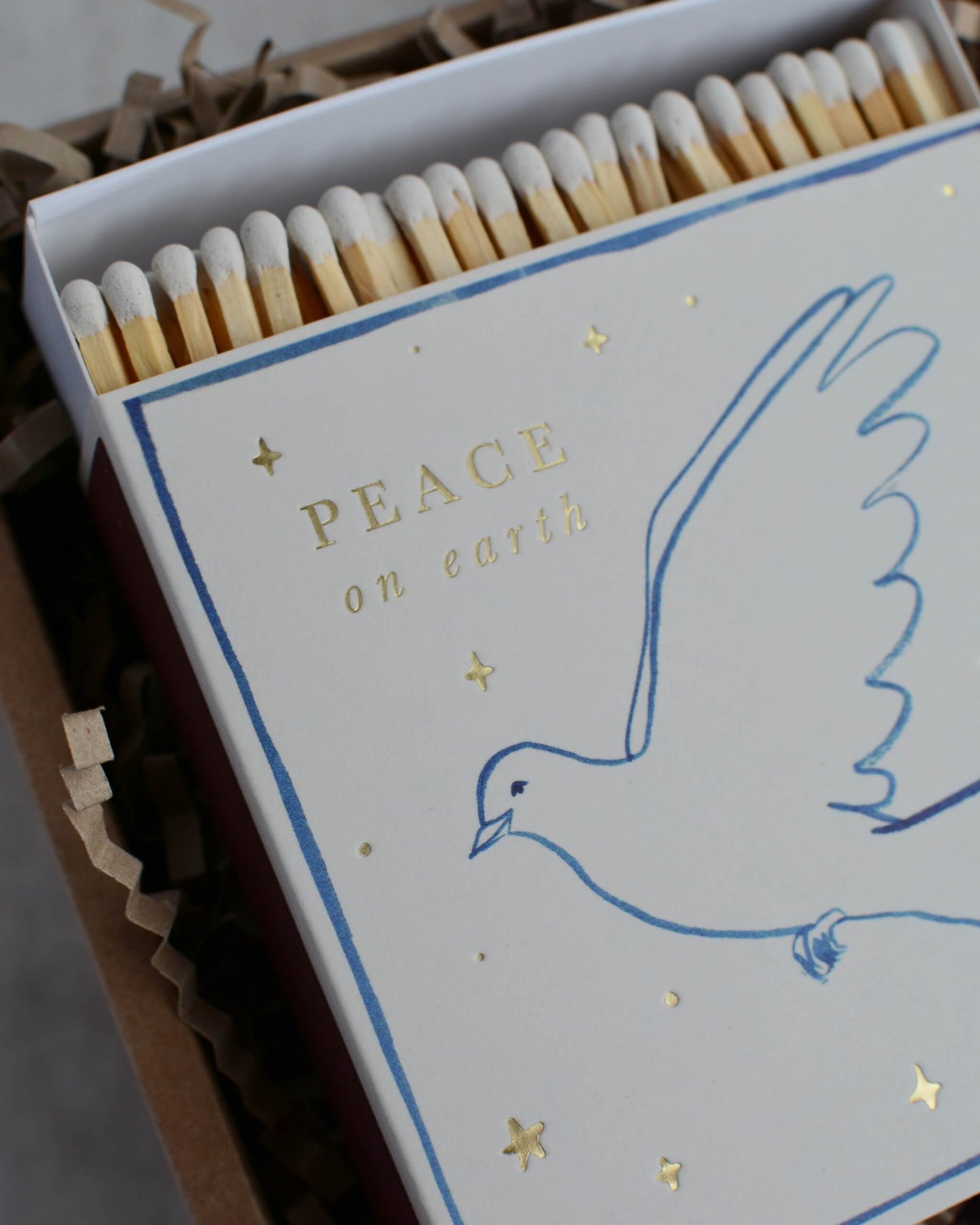 Matches with a dove design and 'Peace on Earth' text on the packaging.