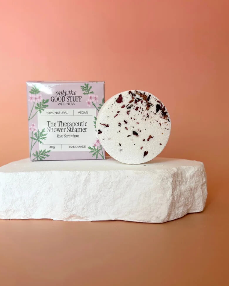 Handmade Therapeutic Shower Steamer with rose and geranium essential oils in eco-friendly packaging.