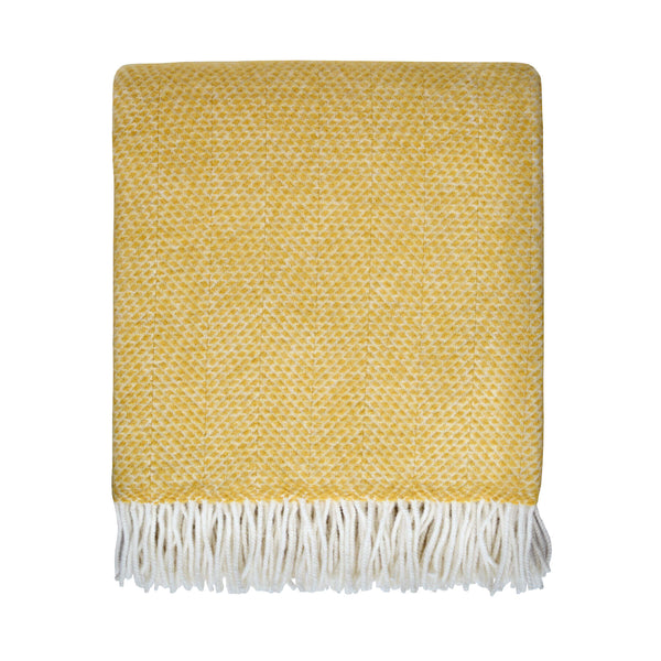a bright yellow throw with a beehive pattern and ivory fringe, shown on plain white background.