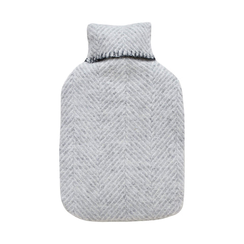 A grey wool hot water bottle with a herringbone pattern, on a white background.