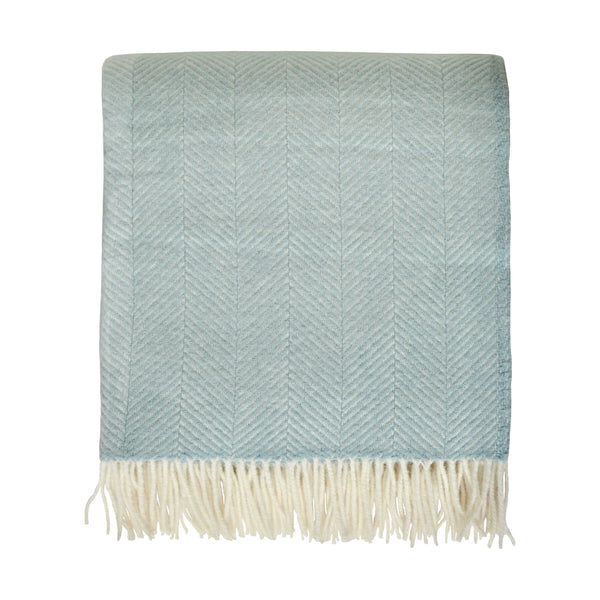 Duck egg blue wool blanket with an ivory fringe. Shown on a white background.