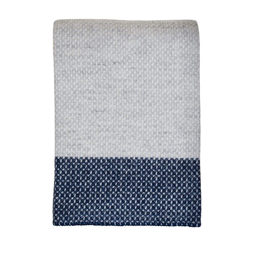Tweedmill light grey and navy cross weave wool throw on a white background.