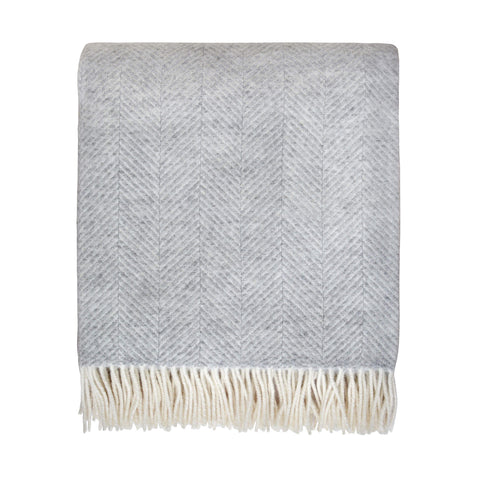 pale grey wool throw with herringbone pattern and ivory fringe, shown on a white background.