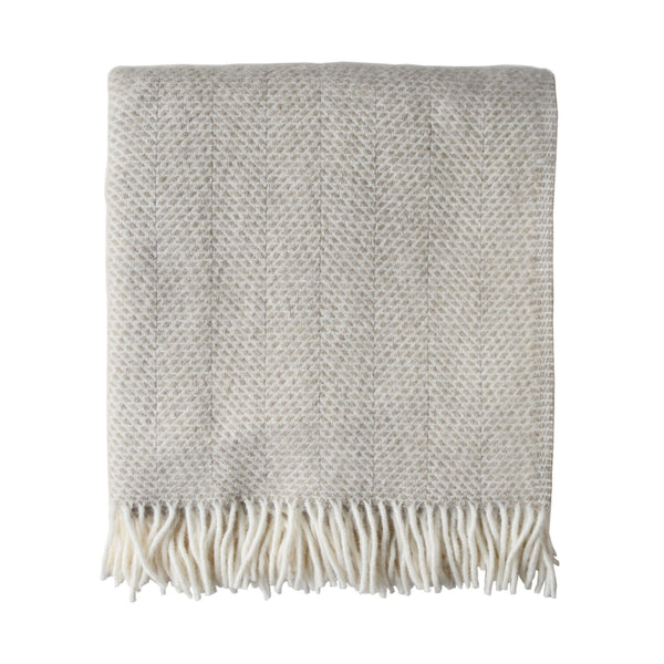 a pale oatmeal wool throw, with a beehive pattern and ivory fringe. Cut out image on a white background.