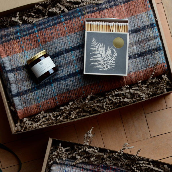 Tinder Box scented candle by The Botanical Candle Co. Gift box with blanket and matches.