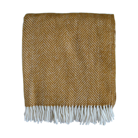 A mustard yellow herringbone wool throw with an ivory fringe, shown on a white background.