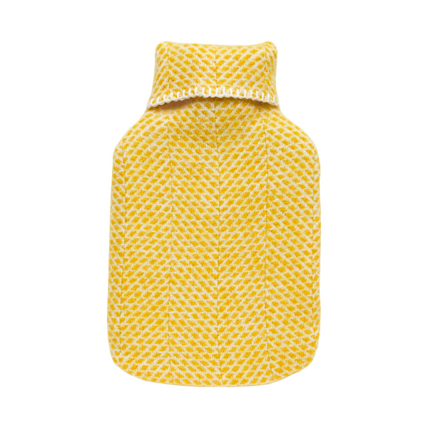 A bright yellow wool hot water bottle with a beehive pattern, on a white background.